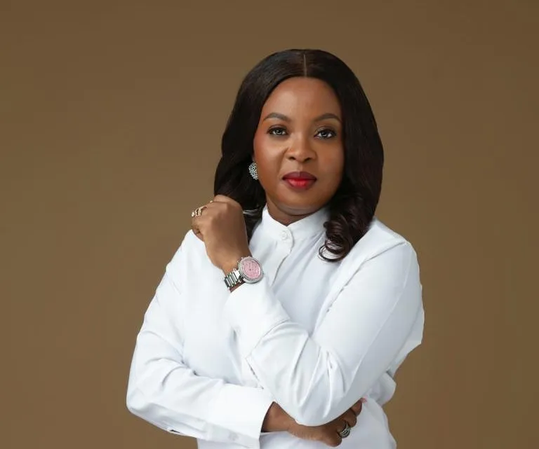 Mabel Adeteye in a white outfit against a brown studio backdrop