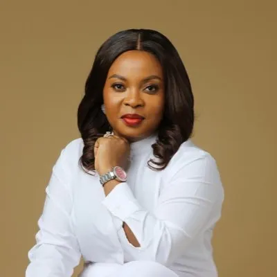 Mabel Adeteye in a white outfit, hand to chin